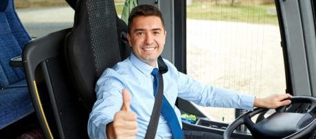 happy driver driving intercity bus and snowing thumbs up